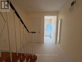 Toronto (St. Andrew-Windfields) townhouse for rent - A hallway with a staircase leading to the second floor.