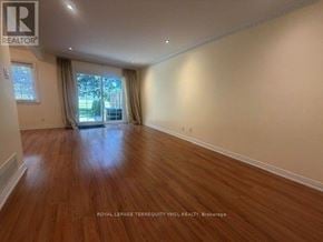 Toronto (St. Andrew-Windfields) townhouse for rent - A room with wooden flooring and a window with curtains.