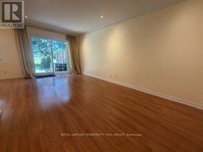 Toronto (St. Andrew-Windfields) townhouse for rent - A room with wooden flooring and a window with curtains.