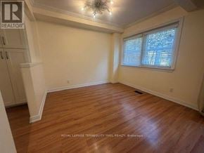 Toronto (St. Andrew-Windfields) townhouse for rent - A room with wooden flooring and a window with blinds.
