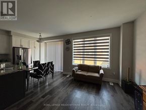 Milton (Walker) townhouse for rent - A living room with a couch, chairs, and a dining table.