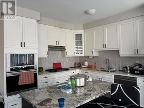 Milton (Walker) townhouse for rent - A kitchen with granite countertops and white cabinets.
