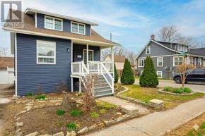 Hamilton (Hamilton Beach) apartment for rent - A blue house with a white porch and a tree stump in the front yard.