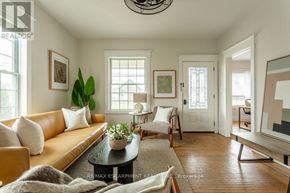 Hamilton (Hamilton Beach) apartment for rent - A living room with a brown sofa, a coffee table, and a painting on the wall.