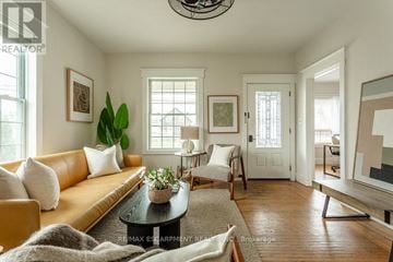 Hamilton (Hamilton Beach) apartment for rent - A living room with a brown sofa, a coffee table, and a painting on the wall.