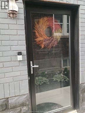 Windsor apartment for rent - A door with a glass window and a wreath on it.