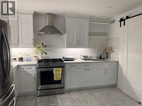 Windsor apartment for rent - A kitchen with a stove top oven and a sink.