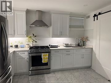 Windsor apartment for rent - A kitchen with a stove top oven and a sink.