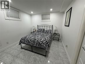Windsor apartment for rent - A bedroom with a zebra print bedspread and a small table.