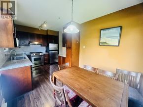 Vancouver apartment for rent - A kitchen with a wooden table and chairs.