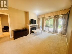 Vancouver apartment for rent - A living room with a television, a sofa, and a coffee table.