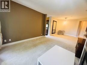Vancouver apartment for rent - A living room with a white coffee table and a brown wall.