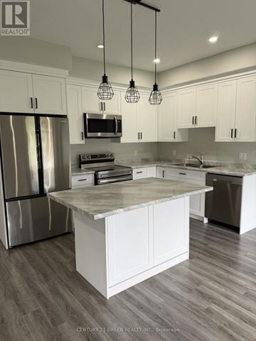 St. Marys townhouse for rent - A modern kitchen with white cabinets and a central island.