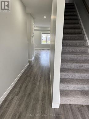 St. Marys townhouse for rent - A hallway with a staircase leading to a bright room.