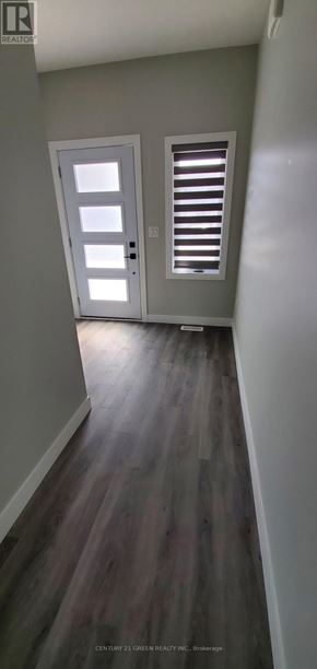 St. Marys townhouse for rent - A hallway with a wooden floor and white walls.