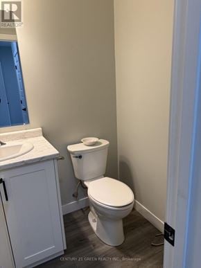 St. Marys townhouse for rent - A white toilet sits next to a sink in a small bathroom.