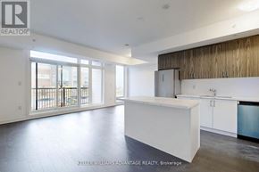 Ajax (Central) townhouse for rent - A spacious kitchen with white countertops and a modern design.