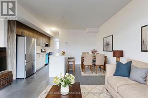 Ajax (Central) townhouse for rent - A well-lit, modern kitchen and living room with a dining area.