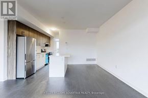 Ajax (Central) townhouse for rent - A spacious kitchen with a white island and stainless steel appliances.