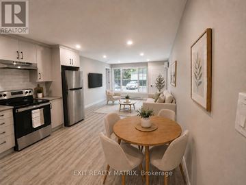 Russell apartment for rent - A modern kitchen with a dining table set up in the middle of the room.
