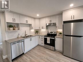 Russell apartment for rent - A modern kitchen with stainless steel appliances and white cabinets.