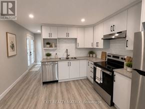 Russell apartment for rent - A modern kitchen with white cabinets and stainless steel appliances.