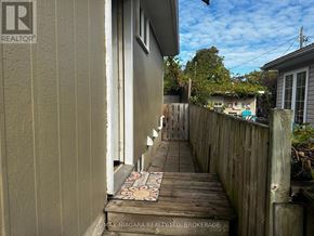 St. Catharines (Port Weller) apartment for rent - A wooden deck with a mosaic tile in the middle.