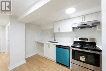 Toronto (Pleasant View) apartment for rent - A kitchen with white cabinets and a stove top oven.