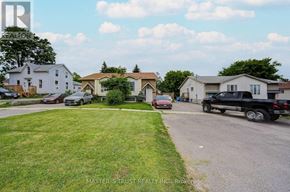 Oshawa (Farewell) apartment for rent - A residential street with houses and parked cars.