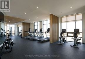 Brampton (Fletcher's Creek South) condo for rent - A gym with treadmills, exercise bikes, and weights is shown.