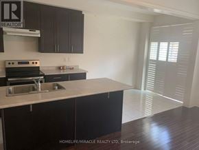 Brampton (Northwest Brampton) townhouse for rent - A kitchen with dark brown cabinets and a white countertop.