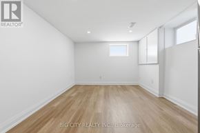 Oshawa (Vanier) multi-family for rent - A room with wooden flooring and white walls.