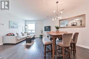 Markham (Middlefield) condo for rent - A well-lit living room with a dining table and chairs.