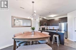 Markham (Middlefield) condo for rent - A modern kitchen with a wooden table and a framed mirror on the wall.