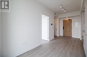 Mississauga (Mississauga Valleys) condo for rent - A spacious room with wooden flooring and white walls.