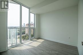 Mississauga (Mississauga Valleys) condo for rent - A large empty room with a view of the cityscape outside.