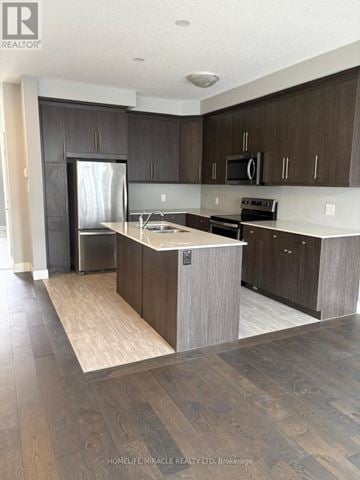 London South (South U) townhouse for rent - A modern kitchen with dark brown cabinets and a central island.