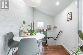 Toronto (Roncesvalles) duplex for rent - A dining room with a white table and chairs.