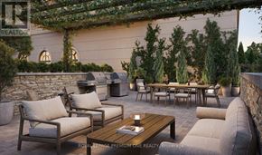 Toronto (Kingsway South) condo for rent - A patio with a table, chairs, and a stone wall.