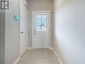 Hamilton (Ryckmans) townhouse for rent - A white door with a glass window in the middle of a hallway.