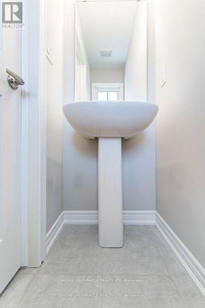Hamilton (Ryckmans) townhouse for rent - A white pedestal sink in a narrow bathroom.
