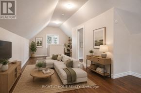 Kitchener multi-family for rent - A well-lit living room with a couch, coffee table, and a television.