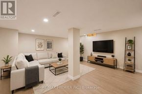 Waterloo townhouse for rent - A living room with a white couch, a coffee table, and a flat screen TV.