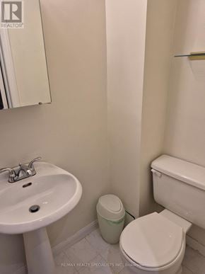 Vaughan (Brownridge) apartment for rent - A white toilet sits next to a white sink in a bathroom.