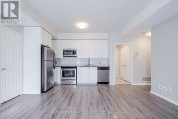 Mississauga (Churchill Meadows) townhouse for rent - A kitchen with white cabinets and a refrigerator.