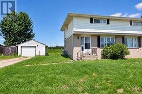Woodstock (Woodstock - North) apartment for rent - A two-story house with a garage and a tree in the front yard.