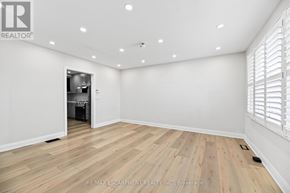 Woodstock (Woodstock - North) apartment for rent - A room with wooden flooring and white walls, with a doorway leading to another room.