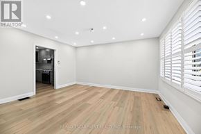 Woodstock (Woodstock - North) apartment for rent - A room with wooden flooring and white walls, with a doorway leading to another room.
