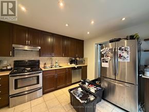 Toronto (Trinity-Bellwoods) apartment for rent - A kitchen with a refrigerator, oven, and microwave.