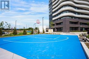 Vaughan (Steeles West Industrial) condo for rent - A basketball court is located in front of a multi-story building.